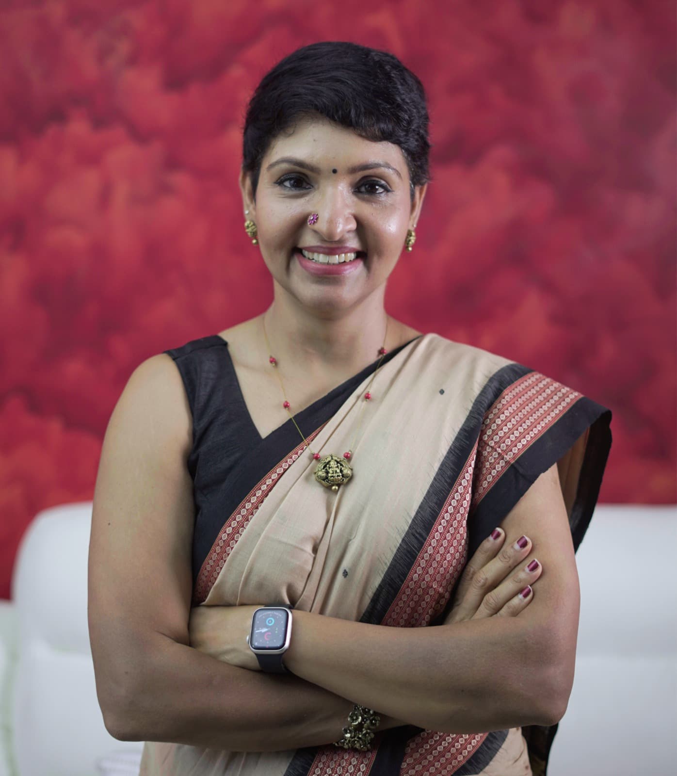 Coach Srividya seated on a couch